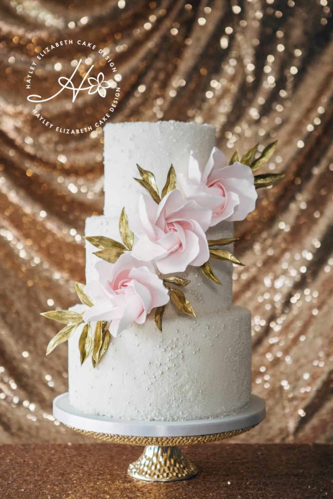 Textured wedding cake with contemporary roses and gold leaves. White, gold and pink wedding cake, elegant wedding cake, sugar flowers, Hampshire and Dorset cake design, wedding cake inspiration