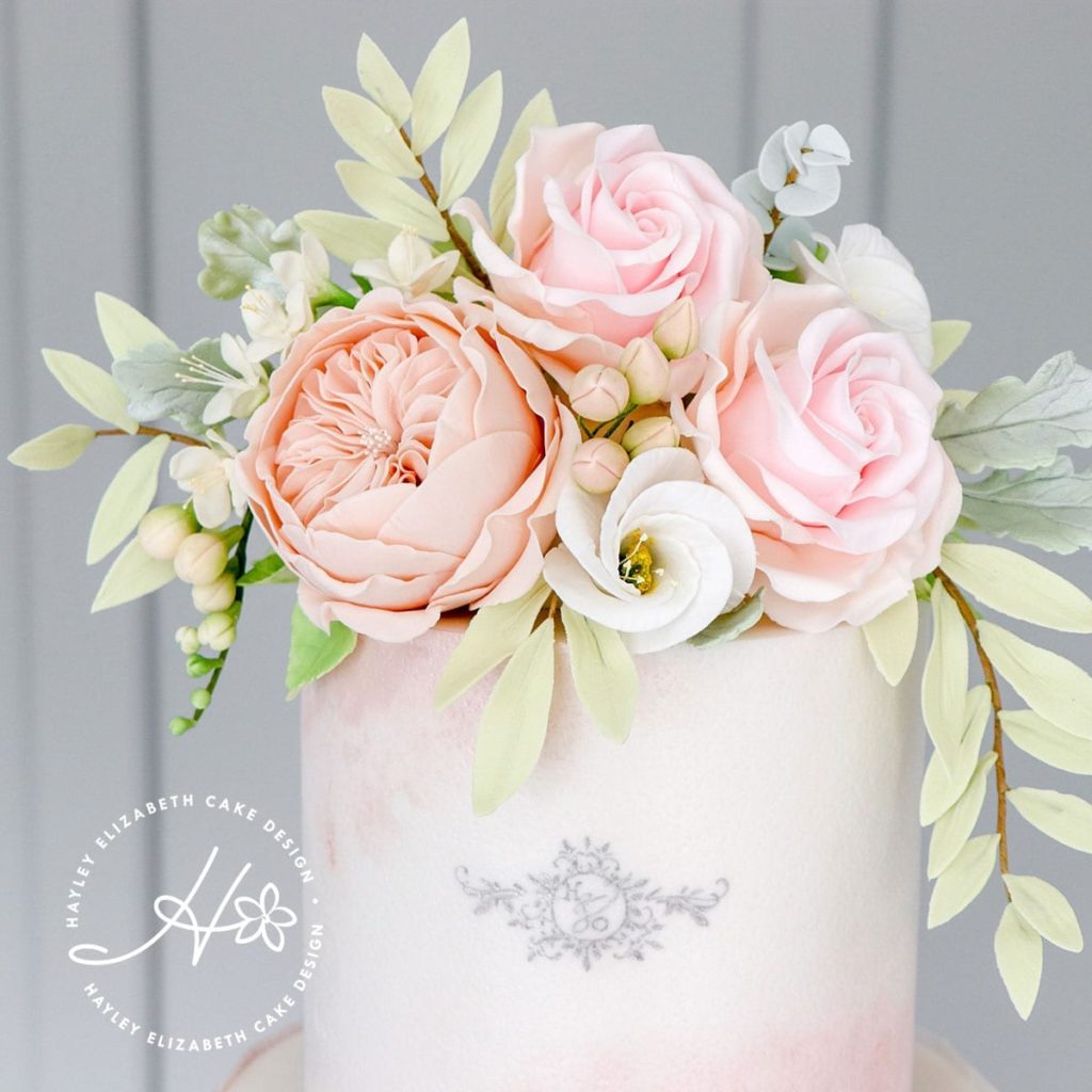 Luxury wedding cake from Hayley Elizabeth Cake Design, UK cake designer. Blush wedding cake, neutral sugar flowers, luxury dessert table, white wedding cake, elegant wedding cake, wedding cake ideas, painted wedding cake.