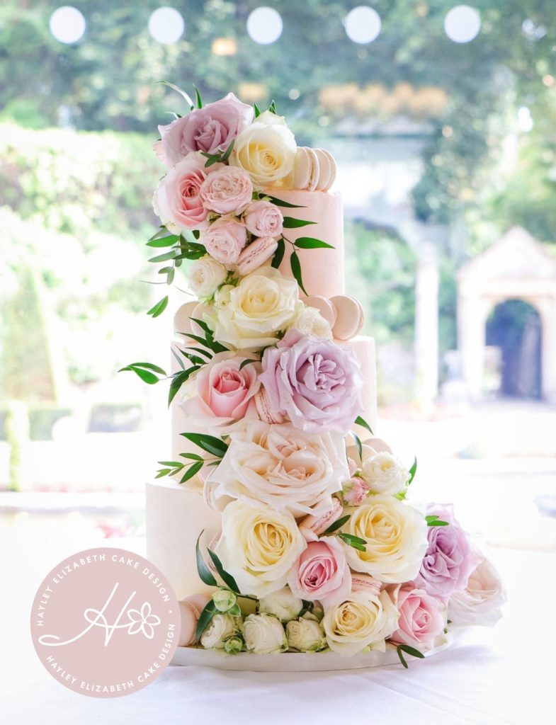 Luxury white wedding cake with macarons and fresh flowers. Spring wedding cake, summer wedding cake, elegant wedding cake, wedding cake inspiration, Hampshire and Dorset cake design